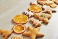 Christmas gingerbread cookies and dried orange and spices on white table Royalty Free Stock Photo