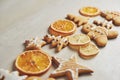 Christmas gingerbread cookies and dried orange and spices on white table Royalty Free Stock Photo