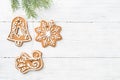 Christmas Gingerbread cookies are hanging on spruce over white w Royalty Free Stock Photo