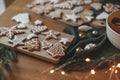 Christmas gingerbread cookies with icing on festive rustic table with decorations and golden lights. Merry Christmas! Delicious Royalty Free Stock Photo