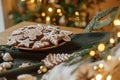 Christmas gingerbread cookies with icing in plate on festive rustic table with decorations against golden illumination. Merry Royalty Free Stock Photo