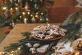 Christmas gingerbread cookies with icing in plate on festive rustic table with decorations against golden illumination. Merry Royalty Free Stock Photo