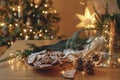 Christmas gingerbread cookies with icing in plate on festive rustic table with decorations against golden illumination. Merry Royalty Free Stock Photo