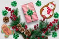 Christmas gingerbread cookies and New Year decorations on white background. Greeting card with a gift, fir branches, pine cones Royalty Free Stock Photo