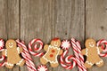 Christmas gingerbread cookies, and peppermints on rustic wood Royalty Free Stock Photo