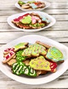Christmas gingerbread cookies on three plates by wooden table Royalty Free Stock Photo