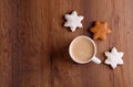 Christmas gingerbread cookies on a wooden background with aromatic coffee and cinnamon sticks Royalty Free Stock Photo