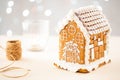 Christmas gingerbread house decoration on background of defocused lights. Hand decorated. Royalty Free Stock Photo