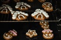 Christmas gingerbread house shaped cookies with white snow icing baking in the oven. Homemade festive traditional gingerbread men Royalty Free Stock Photo