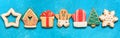 Christmas gingerbread in line on a blue grunge background , border. Various colored gingerbread cookies, banner. Top view, flat