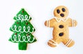 Christmas gingerbread man cookie and Christmas tree cookie isolated on white background. Royalty Free Stock Photo