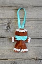 Christmas gingerbread man on old wooden background. Funny felt gingerbread man ornament. Christmas symbol. Top view