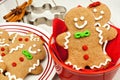 Christmas gingerbread men cookies in red bowl on white wood Royalty Free Stock Photo