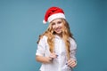 Christmas girl. Beautiful teen model in santa hat isolated on background Royalty Free Stock Photo