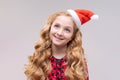 Christmas girl. Beautiful teen model in santa hat isolated on background Royalty Free Stock Photo