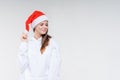 Christmas girl. Beautiful teen model in santa hat  on background Royalty Free Stock Photo