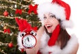 Christmas girl in santa hat, fir tree, alarm clock Royalty Free Stock Photo