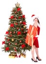 Christmas girl in santa hat, fir tree, gift box Royalty Free Stock Photo