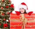 Christmas girl in santa hat, fir tree, gift box. Royalty Free Stock Photo
