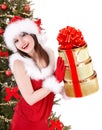 Christmas girl in santa hat, fir tree, gift box. Royalty Free Stock Photo