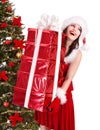 Christmas girl in santa holding stack gift box. Royalty Free Stock Photo