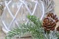 Christmas glass candle decorated with tree branch and cones