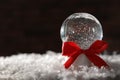 Christmas glass globe with artificial snow on blurred background Royalty Free Stock Photo