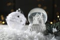 Christmas glass globe with artificial snow on table Royalty Free Stock Photo