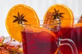 Christmas glass of red mulled wine on table with cinnamon sticks, branches of Christmas tree, snow, Royalty Free Stock Photo