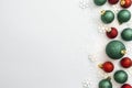 Christmas glitered green and red baubles, balls isolated on snow. Winter abstract border mockup. Royalty Free Stock Photo