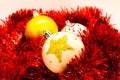 Christmas Globes on red tinsel isolated on white. Handmade decoration.