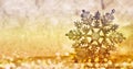 Christmas glowing golden snowflake on blurred background.