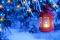 Christmas glowing lantern in the forest on a Christmas tree with lights Royalty Free Stock Photo