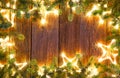 Christmas glowing stars and fir on wood