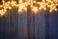 Christmas glowing stars on vintage wood