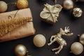 Christmas gold gift box, tree, reindeer and glitter baubles on s Royalty Free Stock Photo