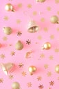 Christmas gold ornament pink background.