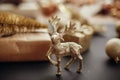 Christmas gold reindeer and gift box with tree on background of Royalty Free Stock Photo