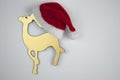 Christmas gold toy deer and Santa hat on white  background Royalty Free Stock Photo