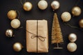 Christmas gold tree and gift box with glitter baubles on stylis Royalty Free Stock Photo