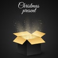 Christmas golden box with a secret gift for the holiday. Abstract glow and golden lights. Dark background. Open magic gift box. Ve