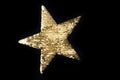 Christmas golden glitter star isolated on black background. Sequin star Royalty Free Stock Photo