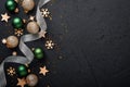 Christmas golden, green and silver balls baubles dark black background. Christmas Decoration. Holiday Decorations with gold bauble Royalty Free Stock Photo