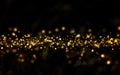 Christmas golden light shine particles bokeh on black background, holiday. Royalty Free Stock Photo