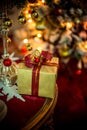 Christmas golden present behind the lights of a Christmas tree Royalty Free Stock Photo