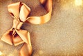 Christmas golden satin ribbon bow Royalty Free Stock Photo