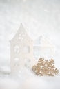 Christmas golden snowflake, decorative houses on a white snow. Blurred background with beautiful bokeh. Shallow depth of