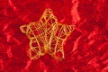 Christmas golden star of wire over red Royalty Free Stock Photo