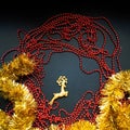 Christmas golden tinsel, red garland, with gold deer on black background. Happy New Year Banner, Merry Christmas. Xmas Royalty Free Stock Photo