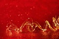 Christmas. Golden xmas lights wire on red background